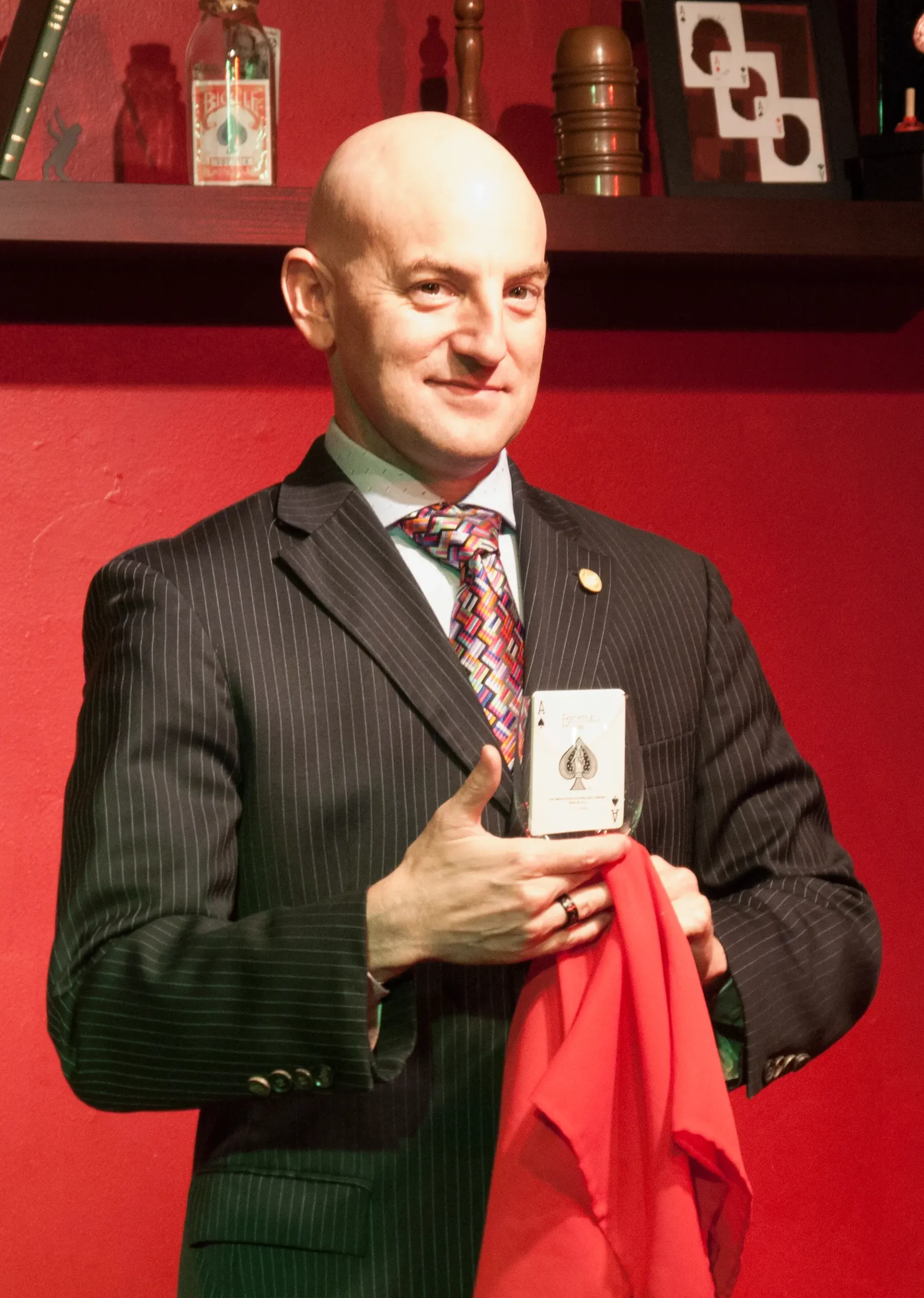 performing a magic trick holding a card